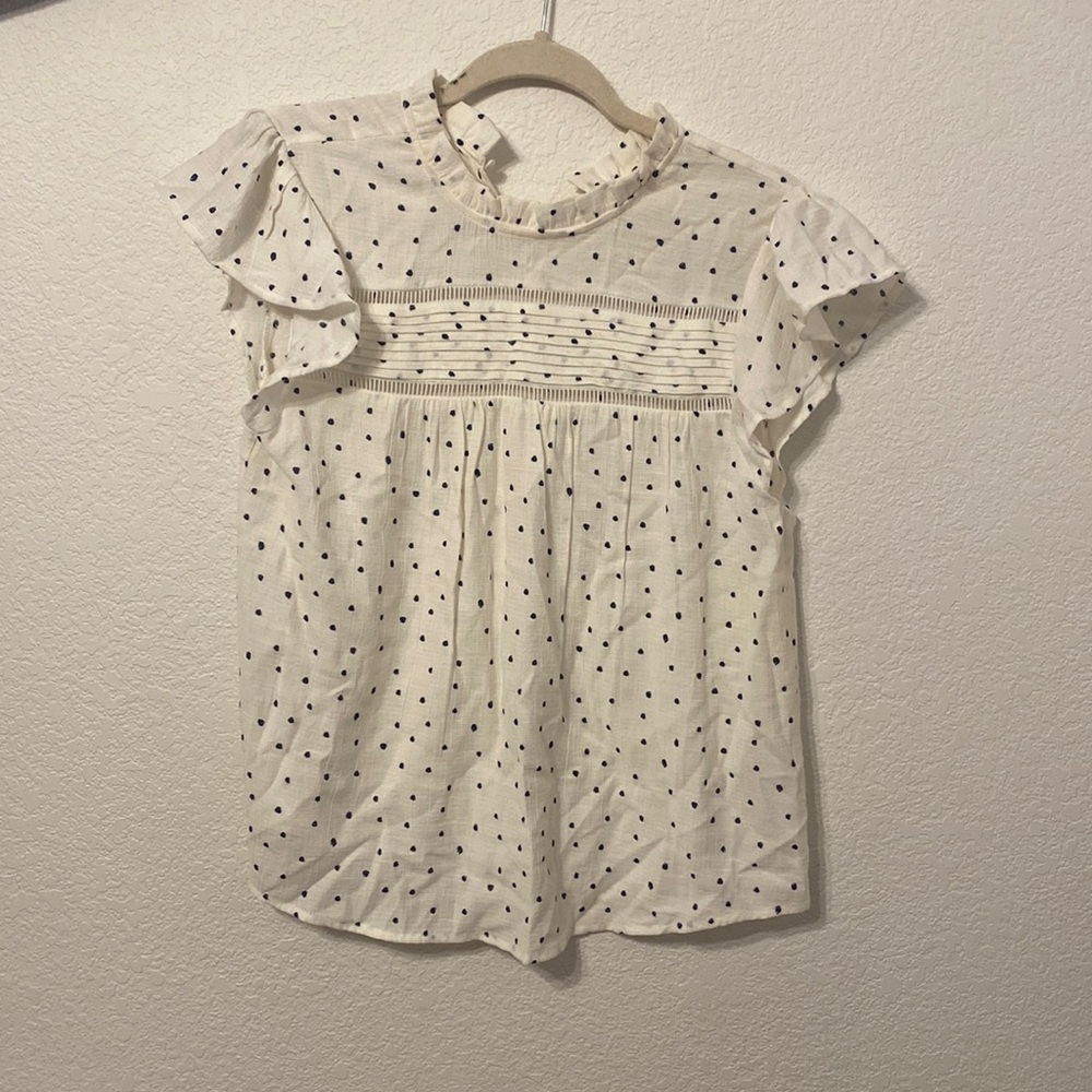 Cute shirt. White with black polka dots. Definitely true tell to size.